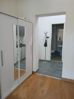 an empty room with a mirror and a room with a kitchen at Vlada in Belgrade
