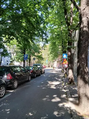 a street with cars parked on the side of the road at Vlada in Belgrade