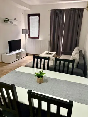 a living room with a table and a couch at Stan Na Dan 111 in Inđija