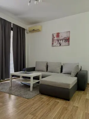 a living room with a couch and a coffee table at Stan Na Dan 111 in Inđija