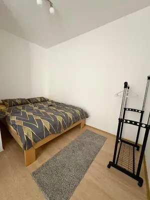 a bedroom with a bed and a ladder in it at Stan Na Dan 111 in Inđija