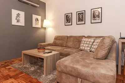 a living room with a couch and a table at Skroman, čist i udoban apartman u Ivana Ribara za dvoje in Belgrade