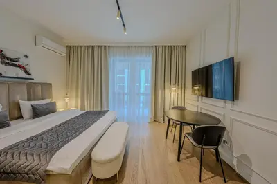 a hotel room with a bed and a table at ZIGZAG Belgrade Waterfront Scala in Belgrade