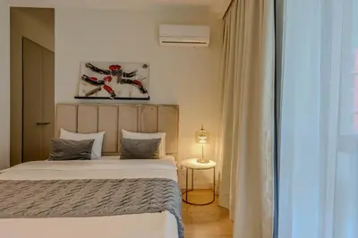 a bedroom with a bed and a lamp in it at ZIGZAG Belgrade Waterfront Scala in Belgrade