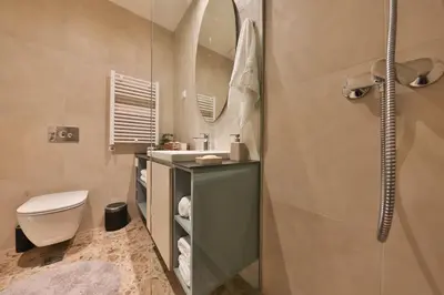 a bathroom with a shower and a toilet and a sink at ZIGZAG Belgrade Waterfront Scala in Belgrade