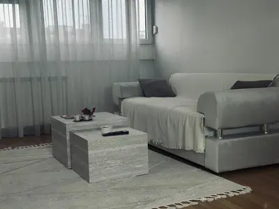 a living room with a couch and a coffee table at Silent hill apartment in Belgrade