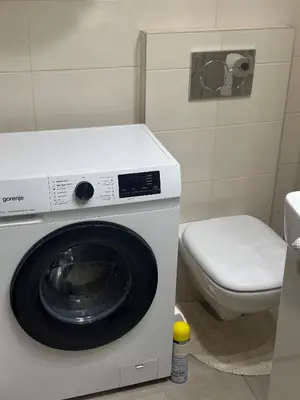 a washing machine in a bathroom with a toilet at Silent hill apartment in Belgrade