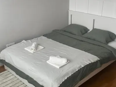 a bed with two towels on top of it at Silent hill apartment in Belgrade