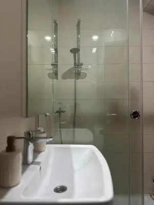 a bathroom with a sink and a glass shower at Silent hill apartment in Belgrade