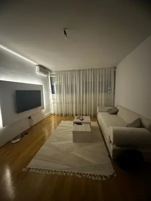 a living room with a couch and a flat screen tv at Silent hill apartment in Belgrade