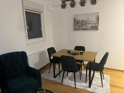 a dining room with a table and chairs at Apartman MINA in Kalugjerica