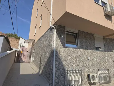 a building with a brick wall with a window at Sun lux in Belgrade