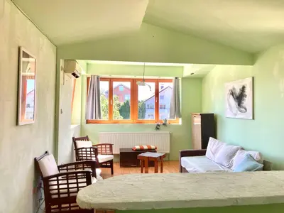 a living room with a couch and a table at Artists Inn, large 2 bed duplex apartment, parking in Železnička Stanica Zemunsko Polje