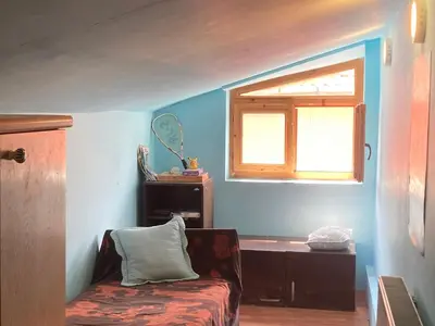 a living room with a couch and a window at Artists Inn, large 2 bed duplex apartment, parking in Železnička Stanica Zemunsko Polje