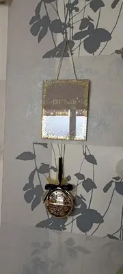 a vase with a sign hanging from a wall at Kucica Slobodica in Bukorovac
