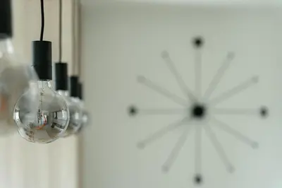 a glass light bulb hanging from a wall at 4 bedroom luxury apartment with park & river view in Belgrade