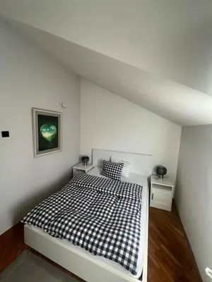 a white bedroom with a black and white bed at Joker 5 in Belgrade