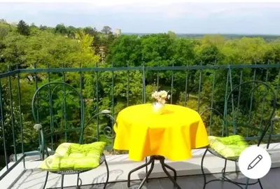 a yellow table and chairs on a balcony at Apartment Bella Vista in Belgrade
