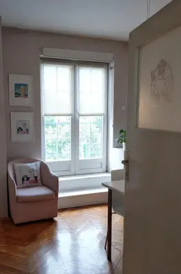 a living room with a chair and a window at Apartment Bella Vista in Belgrade