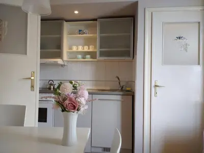 a kitchen with a vase of flowers on a table at Apartment Bella Vista in Belgrade