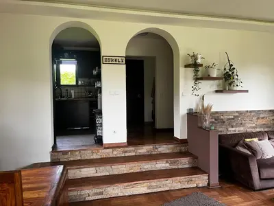 a living room with a staircase leading to a kitchen at Zelena Oaza nadomak Beograda in Lipovica