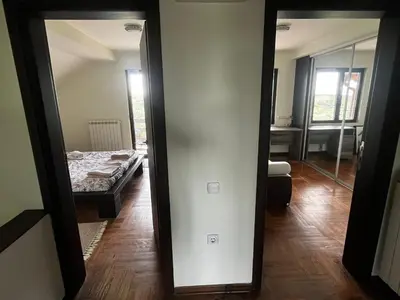 a mirror in a room with a bed at Zelena Oaza nadomak Beograda in Lipovica