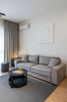 a living room with a couch and a table at BW Lux apartments Beograd na vodi in Belgrade