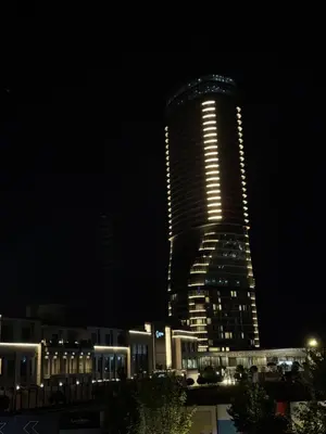 a tall building with lights on it at night at BW Lux apartments Beograd na vodi in Belgrade