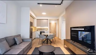 a living room with a couch and a table at BW Lux apartments Beograd na vodi in Belgrade