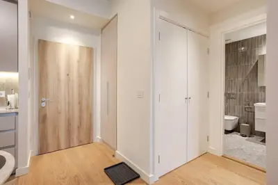 a bathroom with white walls and a sliding door at BW Lux apartments Beograd na vodi in Belgrade