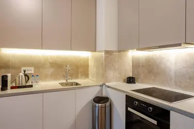 a kitchen with white cabinets and a sink at BW Lux apartments Beograd na vodi in Belgrade