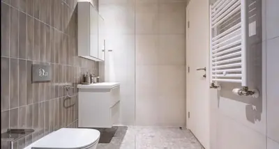 a white bathroom with a toilet and a shower at BW Lux apartments Beograd na vodi in Belgrade