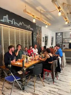 a group of people sitting at a table in a restaurant at Hostel Fair and Square in Belgrade