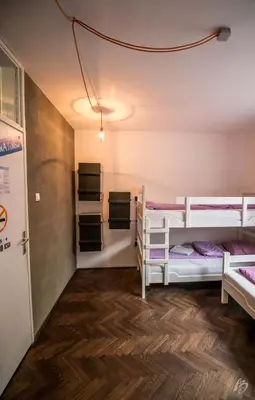 a room with three bunk beds and a hallway at Hostel Fair and Square in Belgrade