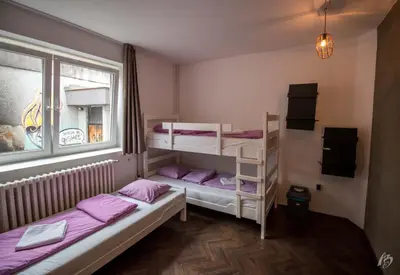 a room with two bunk beds and a window at Hostel Fair and Square in Belgrade