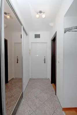 a hallway with a mirror and a white door at Apartment Lilly in Belgrade