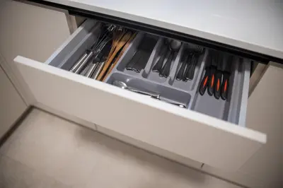 a drawer in a cabinet filled with utensils at Maison Royale Premium Apartment in Belgrade