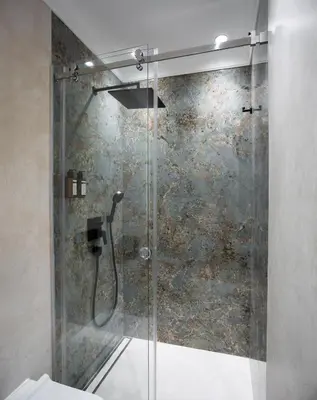 a shower with a glass door in a bathroom at Maison Royale Premium Apartment in Belgrade