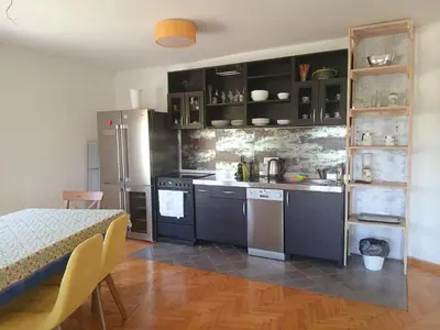 a kitchen with black cabinets and stainless steel appliances at Kalemegdan in Belgrade