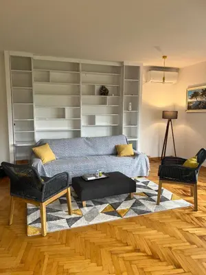 a living room with a bed and two chairs at Kalemegdan in Belgrade