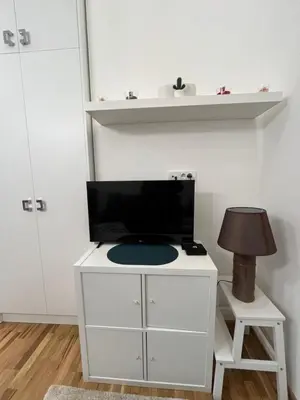 a white cabinet with a tv on top of it at Forests nest in Belgrade