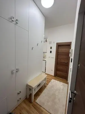 a white room with a bench and a door at Forests nest in Belgrade