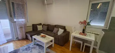 a living room with a couch and two tables at Miletić Lux in Zemun