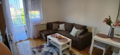 a living room with a couch and a table at Miletić Lux in Zemun