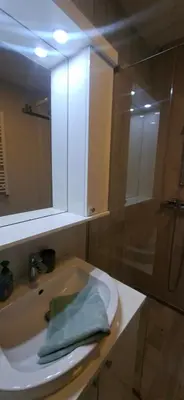 a bathroom with a sink with a green towel on it at Miletić Lux in Zemun