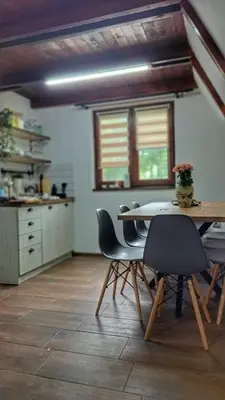 a kitchen with a table and chairs in a room at Kucica na Dunavu in Kovin