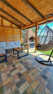 a patio with a hammock and a swing at Kucica na Dunavu in Kovin