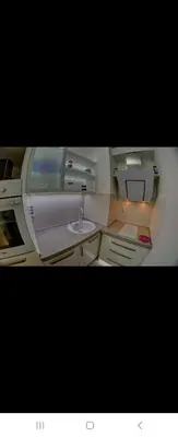 a small bathroom with a sink in an airplane at Belvile one bedroom apartment in Belgrade