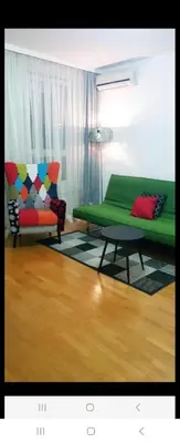 a living room with a couch and a coffee table at Belvile one bedroom apartment in Belgrade