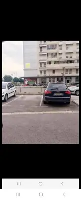 a car parked in a parking lot in front of a building at Belvile one bedroom apartment in Belgrade